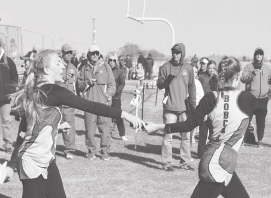 Abby Stallbaumer passes the baton to Delaynie Laible in the girls 4x400 relay. The girls placed 5th with a time of 4:41.65. (Courier photo by Loleta Connell)