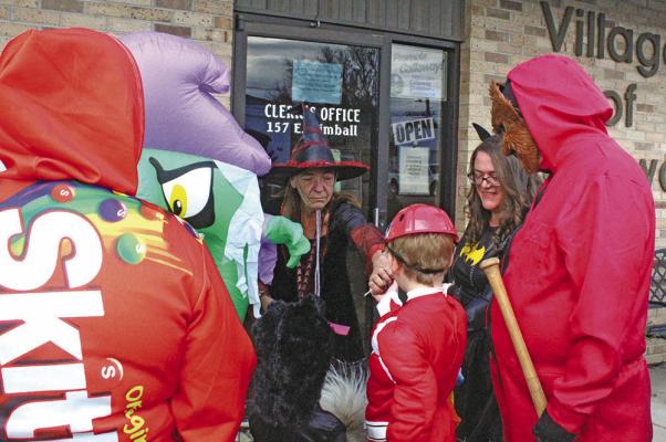 Callaway Village Clerk Lori Bonde was anything but “wicked” as she handed out treats to the kiddos – and even had one for their dog!