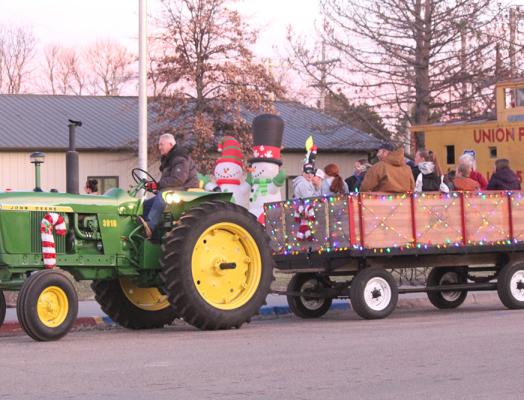 Darrell Fahnholz breaks out one of his classic tractors to provide wagon rides through downtown Callaway as part of the Old Fashioned Christmas celebration. It is a favorite activity during the event, being held this year on Dec. 3. (Courier file photo)