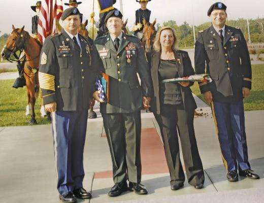1SG William Schaad of Callaway, second from left, was joined by his wife, Janet, at his retirement ceremony at Fort Riley, Kansas in 2005. The Mounted Color Guard is shown in the background. (Photo courtesy Bill Schaad)