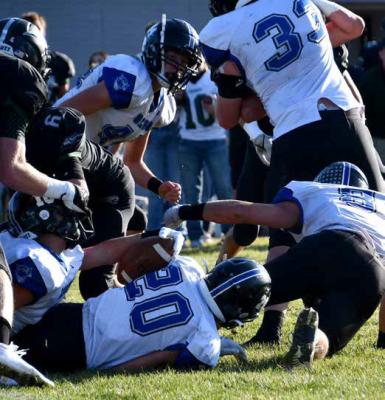 Courier photos by Loleta Connell (#10) Ball carrier Conner Paulsen stretches for the first down in a tough battle against Howells-Dodge Friday afternoon.