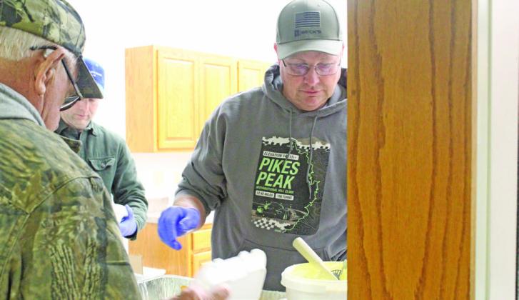 Duane Kimball puts a pile of breaded shrimp on the plate of one of the hundreds of dinner guests at Callaway’s Fish Fry on March 6. (Courier photos by Ellen Mortensen)