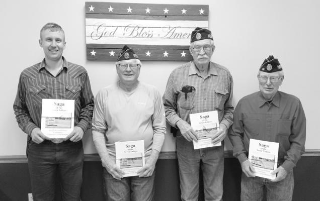 The Callaway American Legion Auxiliary Unit 59 presented the book 'Saga of the Seven Valleys' to the local Legion members of Post 59 at their Dec. 7 meeting. The books were generously donated by the Seven Valleys Historical Society as a combined endeavor with the Auxiliary to thank the Legionnaires during this holiday season for their service to our Country and our Community. Pictured from left are Wayne Belew, Charlie Jorgenson, Dave Chesley, and Dale Estergard. (Photo courtesy Jo Chesley)
