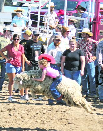 ABOVE LEFT: Jacob Haren of Callaway had a great time in Sunday night's tie down roping event. ABOVE RIGHT: Lots of kids took a try at Mutton Bustin' Sunday, but few had a jumping sheep like Esmae Eggleston drew!