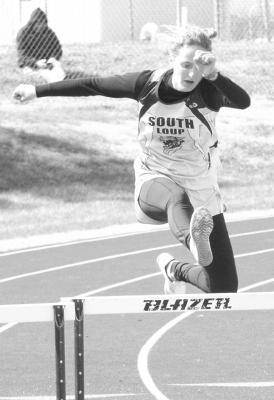 Anna Coleman jumps over a hurdle at the track meet in Elwood last week. Unfortunately her time was not quite fast enough to qualify for finals in the event.