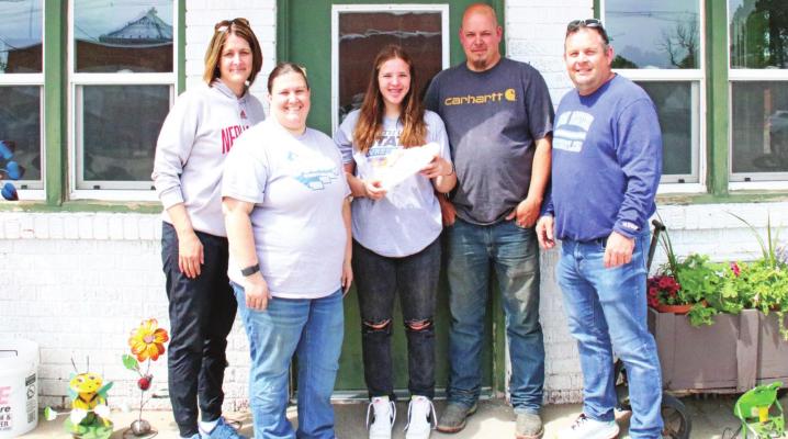 From left: Barb Hughes, Jessie Bloomer, Lila Bloomer, Jeremy Bloomer, Jon Hughes stand post for a photo after awarding Lila with the Max Wrestling Scholarship and Nike shoes in honor of Barb and Jon's son Max who died in a car accident in 2020. Courier photo by Amanda Koubek - Wehnes