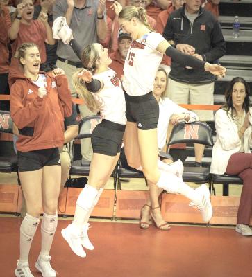 From left: Husker Lindsay Krause, Laney Choboy, and Andi Jackson celebrate earlier this season. (HUSKERS ILLUSTRATED PHOTO)