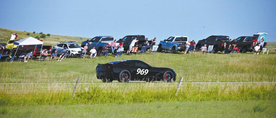Dan Rohrback in his #969 2014 Chevy Corvette zooms past the crowd hitting almost 200 mph in the one-mile shootout near Callaway on Friday, Aug. 11. Rohrback earned the One-Mile King of The Hill title.