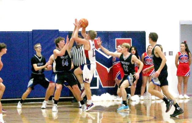 The South Loup defense swarms a Medicine Valley player attempting a shot during last week's contest. (Courier photo by Ronda McFate)