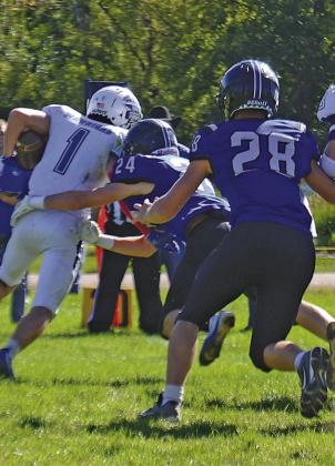 Callan Witthuhn (#24) hones in on the ball carrier in a game earlier this season, while Braxton Cozad (#28) comes in to help. (Courier file photo by Ronda McFate)