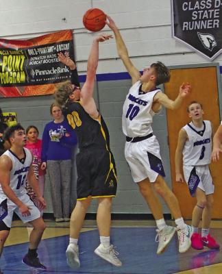 Dylan Pandorf plays strong defense for the Bobcats, knocking away a shot by Mullen in last week’s game.