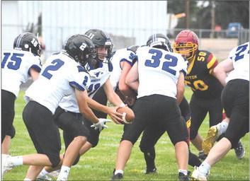 Sophomore Dylan Pandorf hands off to #2 freshman Elijah Cool with fellow teammates #24 Lance Wooters, #15 Dawson Mason, #32 Taytum Wiese and #50 Kyle Bloomer leading the charge. (Courier photos by Loleta Connell)