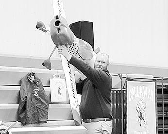 Community Foundation board president Corby Leeper holds up an item for auction at the Gala earlier this year. (Courier file photo)
