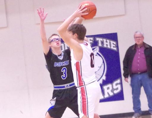 ABOVE: Caleb McFate defends a Sutton player in a sub-district game last week. (Courier photos by Ronda McFate)
