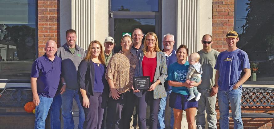 Stacey Guthard holds the CEDC Wheelhorse Award, announced at the Sept. 27 awards banquet and presented to her in person last week. CEDC Director Scotti Ross, pictured to Stacey’s right, presented the award as community members, co-workers, and friends joined in celebrating Stacey at a reception at Security First Bank. (Courier photo by Ellen Mortensen)