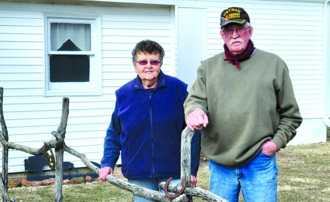Jo and Dave Chesley stand in front of their first home, which they now operate as a short-term rental, Chesley Lodge. It sits on the property homesteaded by Dave’s great-grandfather in 1876. (Courier photo by Ellen Mortensen)