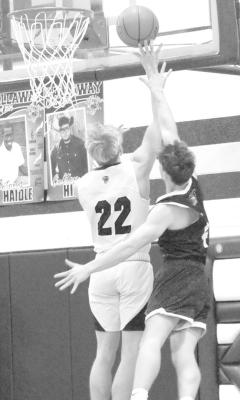 Ethan Furne soars to the basket against a Bertrand defender on Saturday. (Courier photo by Ronda McFate)