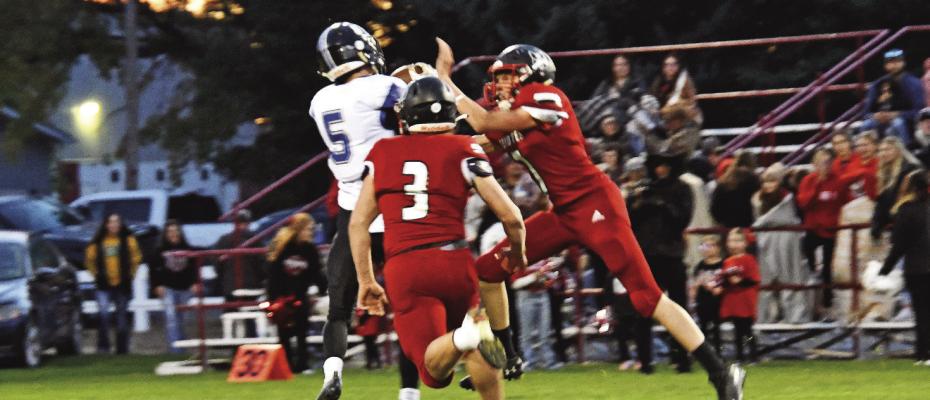 Junior Cache Gracey hauls in the long bomb under double Coyote coverage Friday evening at Merna. Courier photos by Leta Connell