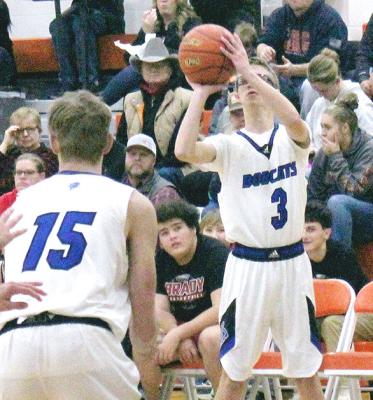 ABOVE: Caleb McFate takes a shot from outside against Brady on Dec. 27. Left: Conner Paulsen takes the ball to the hoop during the holiday tournament at Maxwell last Friday. (Courier photo by Ronda McFate)