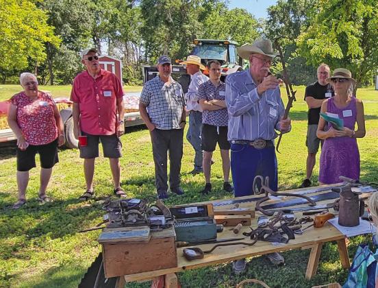 Dave Chesley shared some of the tools used by his great-grandfather Paul Seyerson, who homesteaded north of Callaway in 1876. Dave and his wife Jo now reside on the original place and hosted a 150th anniversary celebration July 11-12. Guests were invited to take their best guess at what these tools were used for. (Photo courtesy Stephanie Peters)