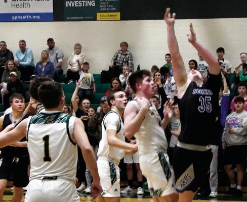 #35 Junior Joey Sallach finds himself far underneath but manages to get his shot off with Irish #15 Junior Brecken Erickson for the push.