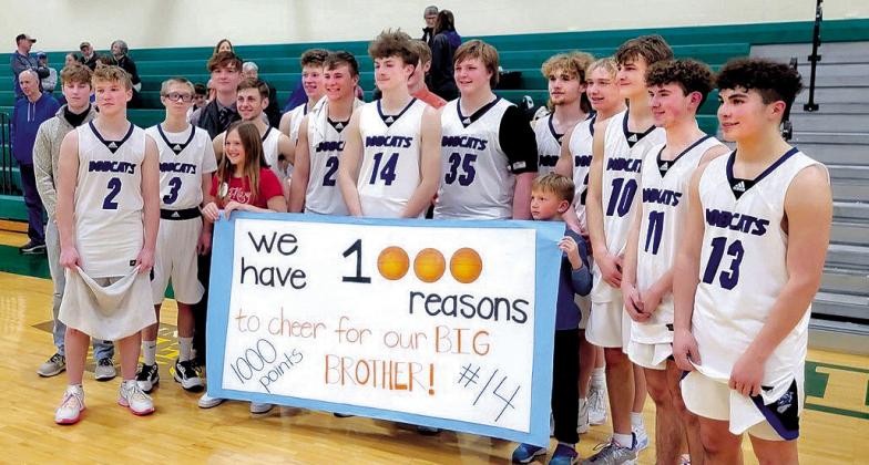 South Loup junior Cache Gracey (#14) scored his 1,000th career point against SEM on Feb. 17. He is surrounded by his teammates and siblings. (Courier photos by Loleta Connel)
