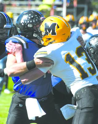 Senior Dawson Doggett ties it up with senior Chase Gracey as the South Loup offense closes in on the endzone. (Courier photos by Loleta Connell)