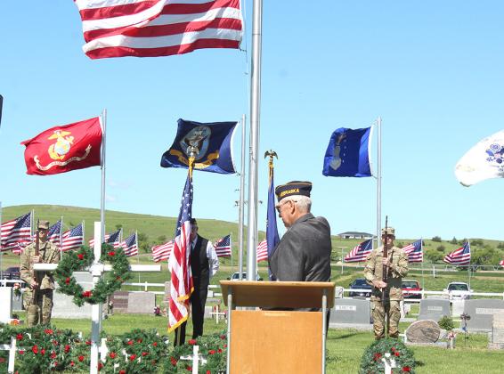 The Callaway American Legion Post 59 hosted a Memorial Day program on Monday, May 27, at Rose Hill Cemetery. Guest speaker was District 6 Commander of the American Legion, Burdette Chappell, pictured at right. (Courier photos by Ellen Mortensen