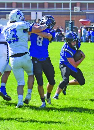 Elijah Cool (#8) blocks for South Loup quarterback Tysen Schacher as he looks to get some positive yards last week against Arapahoe. (Courier photos by Ronda McFate)