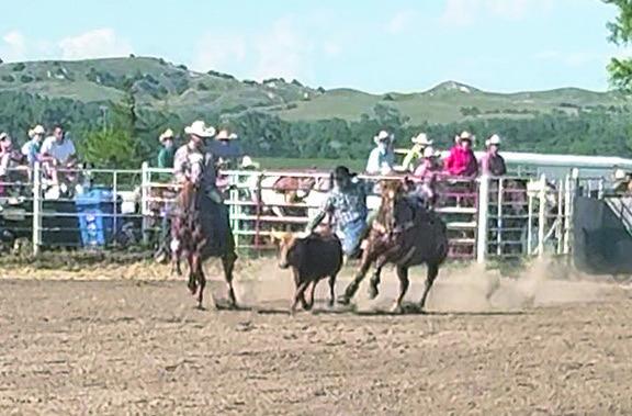 ABOVE: Dawson Doggett dismounts his horse during Sunday night's steer wrestling at the Seven Valleys Rodeo. Doggett placed 5th in the event, after finishing 2nd at Wisner on Friday night and 4th at Clearwater on Saturday. It was a great weekend for this hometown cowboy! (Photo courtesy MaKayla Doggett)