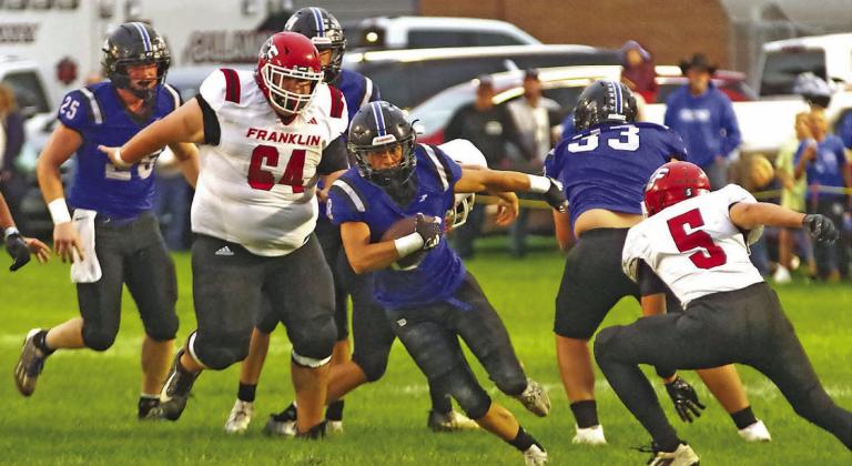 Elijah Cool gets the carry for the Bobcats against Franklin last Thursday, as teammates Malachi Neth (#25) and Tatum Weise (#33) attempt to clear a path for him. The Bobcats ran away with this one by a final of 56-0. (Courier photos by Ronda McFate)