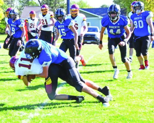 Photos courtesy Loleta Connell ABOVE: #14 Senior Kaden Paulsen wraps up ball carrier #11 Junior Trenton Rushman in action at Callaway on Friday. LEFT: #20 Sophomore AJ Starr receives the handoff from #11 Freshman Dylan Pandorf for a short gain in the Bobcats Homecoming 50-6 victory.