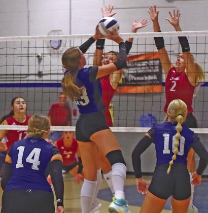 Berklee Preston tries to get the ball over the hands of the Gothenburg blockers in a home match in Arnold on Sept. 10. (Courier photos by Ronda McFate)