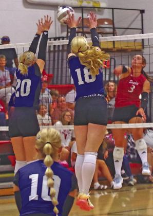 Asa Starr (#20) and Emma Stallbaumer (#18) go up to attempt a block on the Gothenburg hitter.