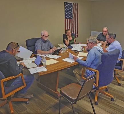 The Callaway Village Board met on April 14 with the audit and budget report the key topic of conversation. Clockwise from left are TJ Elliott, Lawrence Paulsen, City Clerk Lori Bonde, Board Chairman Dan Lewandowski, Darwin Mast, and Mark Kimball. (Courier photo by Ellen Mortensen)