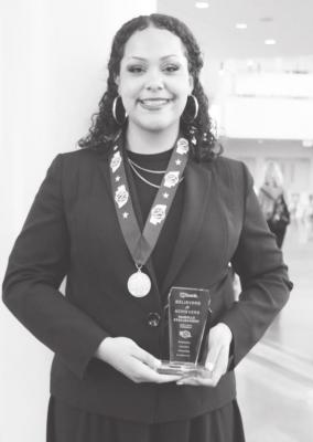 Izzy Stallbaumer poses with her gold medal in poetry and her Believe rs &amp; Achievers award at Kearney High School following the Dl State Speech tournament. (Courier photos by Amanda Wehnes)