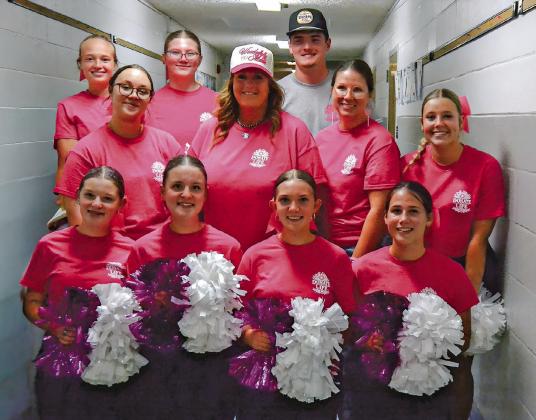 Holly Hornung Remund (middle row two), and Rio Remund (back row far right), join the South Loup cheer squad in supporting breast cancer awareness and organ donation in memory of Riata Remund. Pictured are, front row, from left: Lindsay Christensen, Josie Christensen, Avery Corbin, and EvaLynn Wonch; Row two: Piper Strasburg, Holly Remund, Katie Berglund-Cheer Coach, and Angel Mills; Back row: Jade Bierman, Adalei Tullis, and Rio Remund.