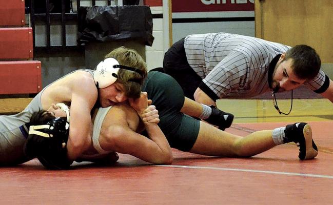 Bobcat wrestler Bo Brennan gets the pin on Kearney Catholic’s Eddie Mueting last week at the final regular season meet of the season. Brennan, a 120-pound sophomore, finished the regular season with a record of 22-14. (Photo courtesy South Loup Sports)