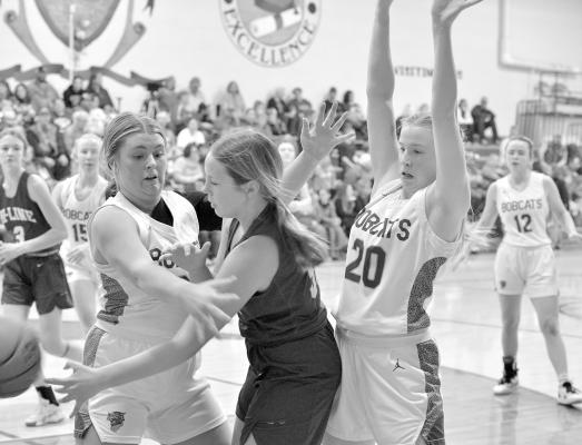 Maggie Birkel and Josie Reiff get the tough trap on Hi-Line opponent. (Courier photo by Patti Schwarz)