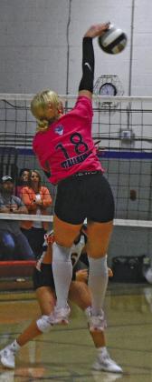 Emma Stallbaumer flies above the net for a kill for the Lady Bobcats in a match last week.