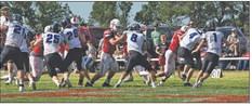 The South Loup defense hones in on the Hemingford ball carrier to make the stop.