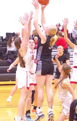 LEFT: Emma Stallbaumer goes over the top of the Hi-Line defenders as she attempts to take the ball to the hoop in last Friday's game.