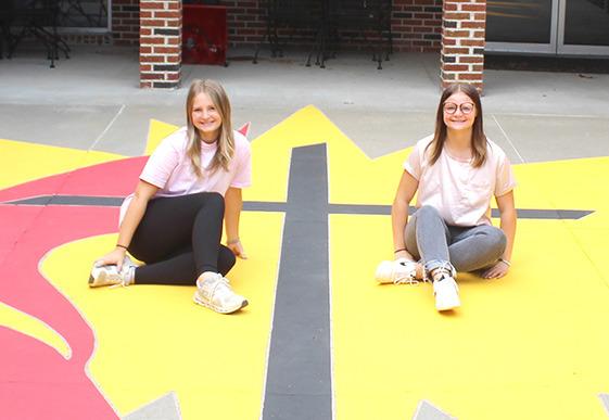 Sisters Tiersa Johnson, left, and Angel Johnson recently completed repainting the cross and flame at the Callaway United Methodist Church. The girls said they did the project simply because it needed done, and they wanted to help. (Courier photo by Ellen Mortensen)