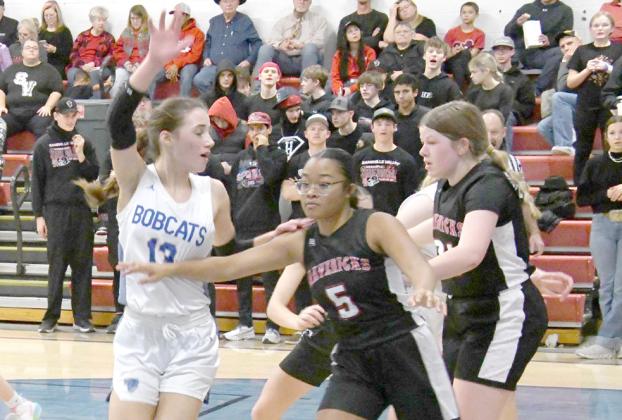 ABOVE: Sophomore EvaLynn Wonch asks for the ball as the Lady Bobcats in bounds the ball against the Mavericks. LEFT: Neltje Reiff stops Maverick #22 Hope Correll as she drives to the hoop and forces a pass. (Courier photos by Loleta Connell)