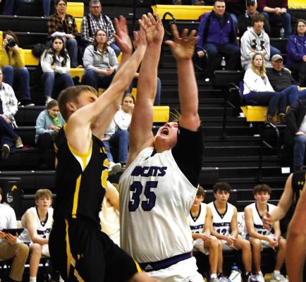 Junior Joey Sallach rebounds and put it back up against Alex Moore in the Bobcats MNAC win over the Broncos 50-39.