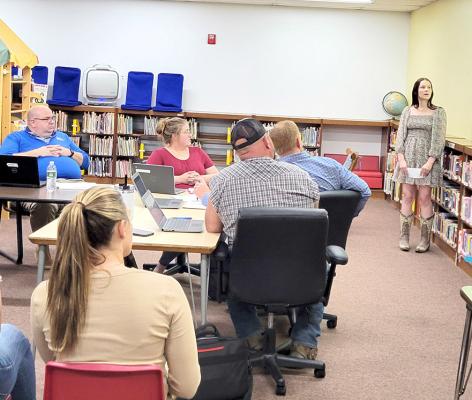 Carleigh Laible, pictured standing facing the camera, gave a presentation to the school board on May 13 outlining why she believes she should be allowed to graduate in December 2024, rather than waiting until May. (Courier photo by Ellen Mortensen)