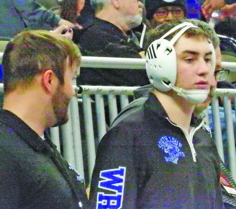 Paxton Bierman gets some pointers from his coaches prior to stepping on the mat at the Nebraska State Wrestling Championships in Omaha last week.