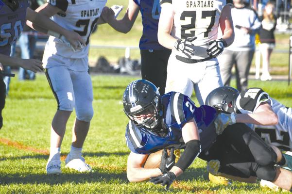 Bobcat ball carrier AJ Starr tries to keep his feet as a Spartan defender duo do all they can to stop his progress.