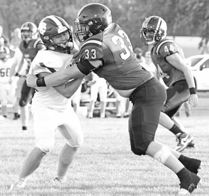 Senior Joey Sallach blocks big in the season opener against Elm Creek.