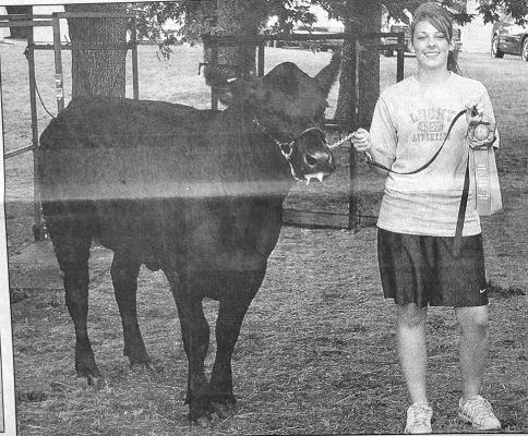 Samantha Pandorf showed the grand champion Simmental breeding heifer at the 2005 Custer County Fair.